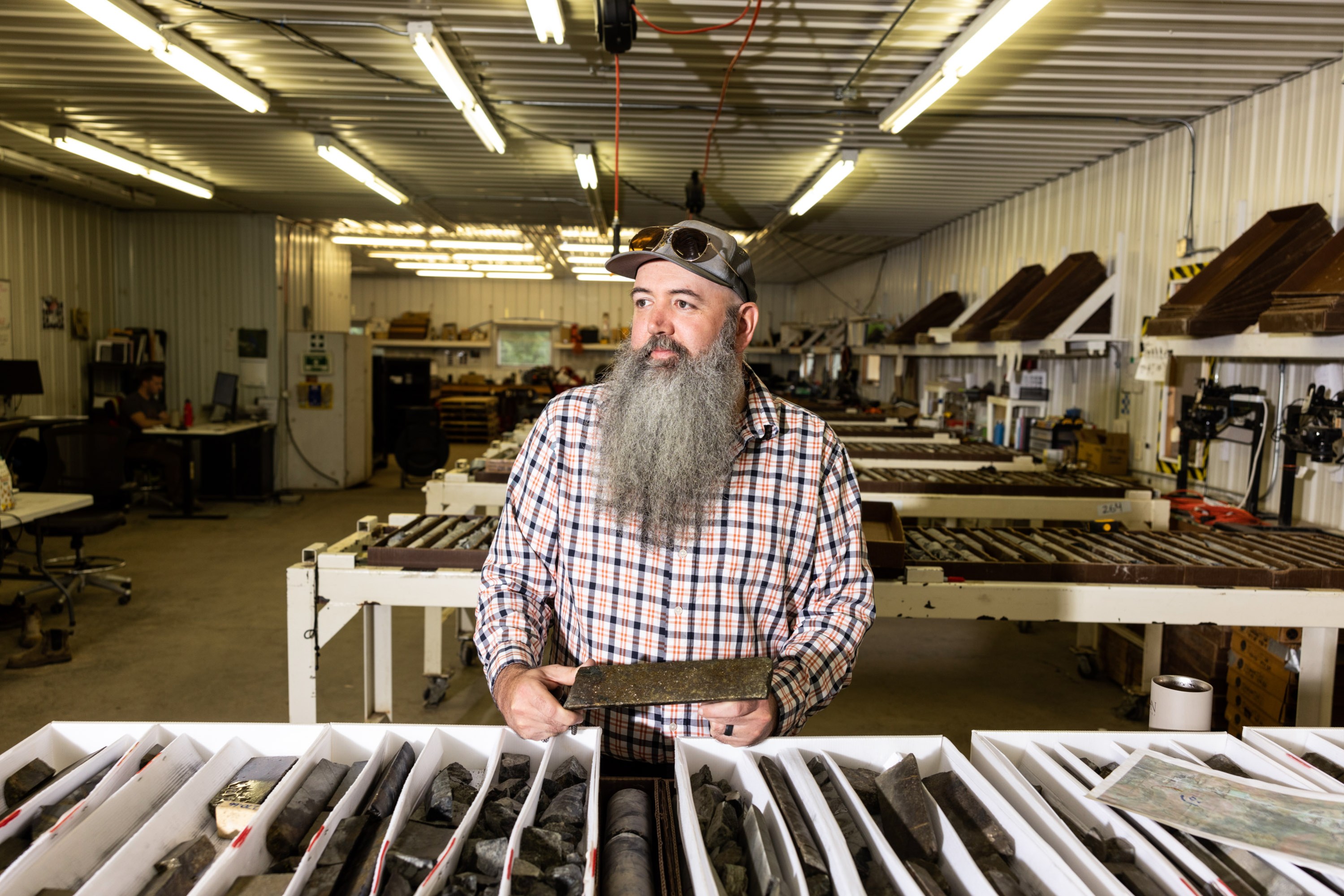 Brian Goldner standing by a table laden with core samples