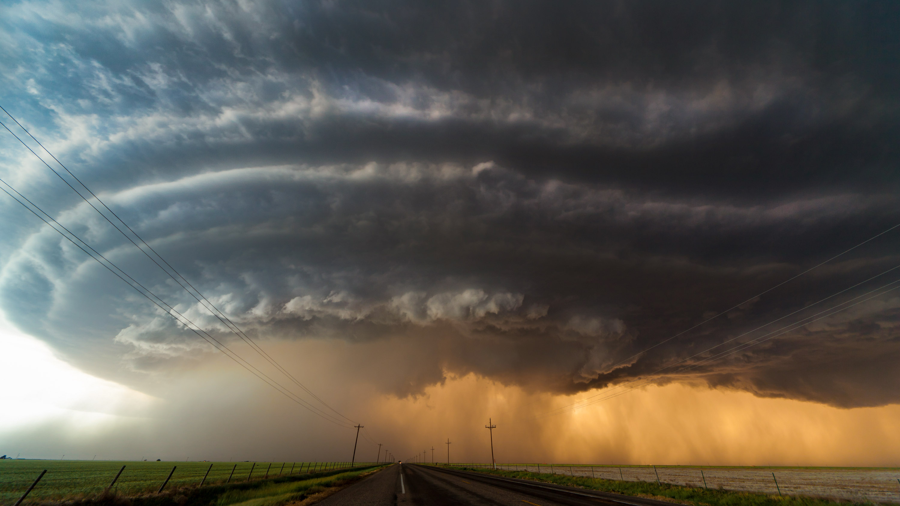 A huge cloud forming a cell over a road